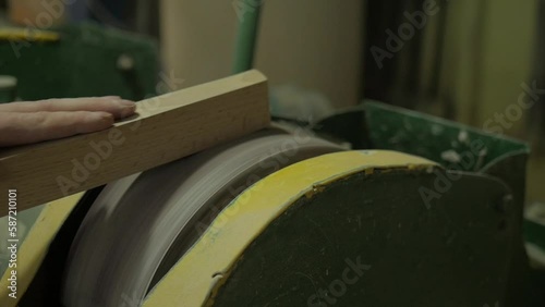 Manual labor for details in the manufacture of furniture. polishing wooden parts