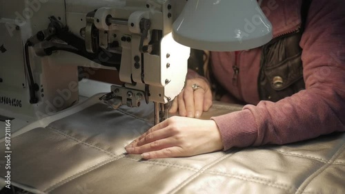 Fabric for furniture upholstery. woman's hands at the sewing machine