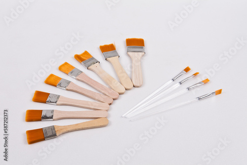 Several small paint brushes were placed on a white background to facilitate background removal