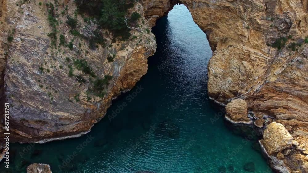 A natural arch in the rock and a bay with turquoise water Delik Deniz. Sights of Turkey. A natural arch in the rock and a bay with turquoise water Delik Deniz. Sights of Turkey.