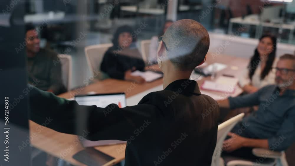 Confident female professional giving a presentation in a meeting, addressing her team on a project and sharing her ideas. Young business woman taking the lead on an office collaboration.
