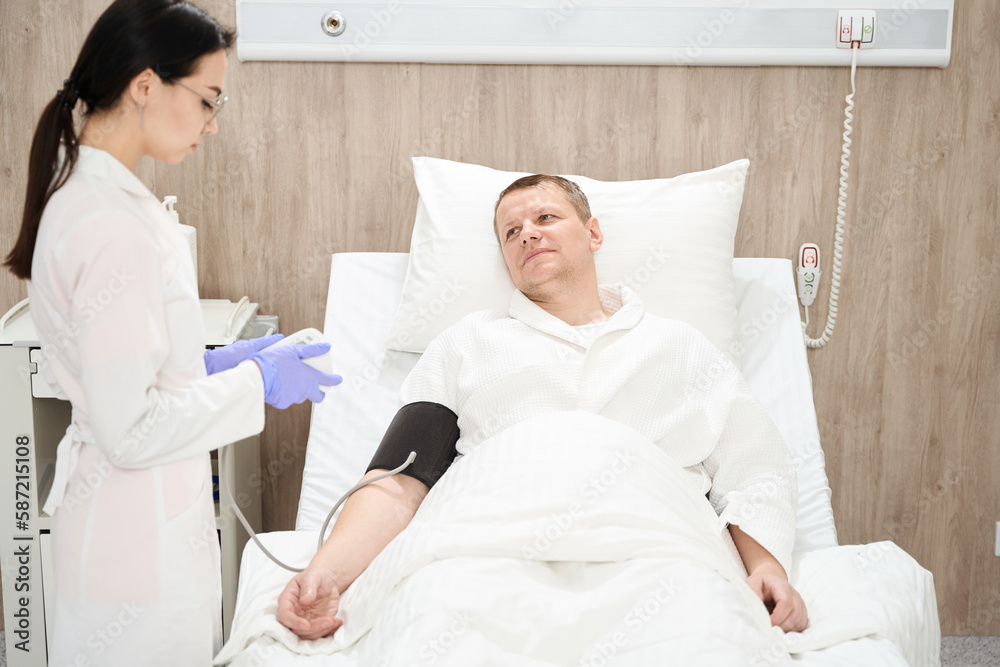 Handsome male is receiving professional diagnosis in the medicine clinic Handsome male is receiving professional diagnosis in the medicine clinic