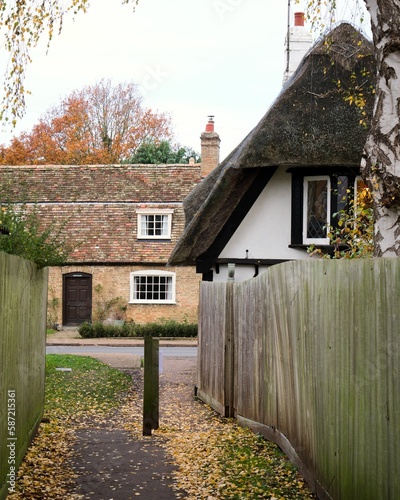 Vertical shot of beautiful thatched cottage in Hemingford Grey, England photo