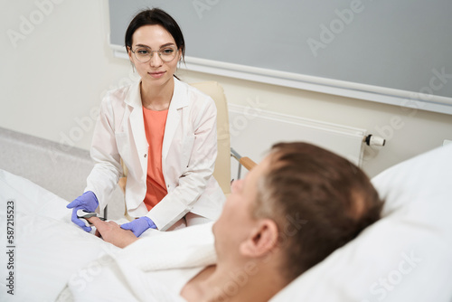 Elegant Caucasian female doctor is communicate with patient in the medicine ward