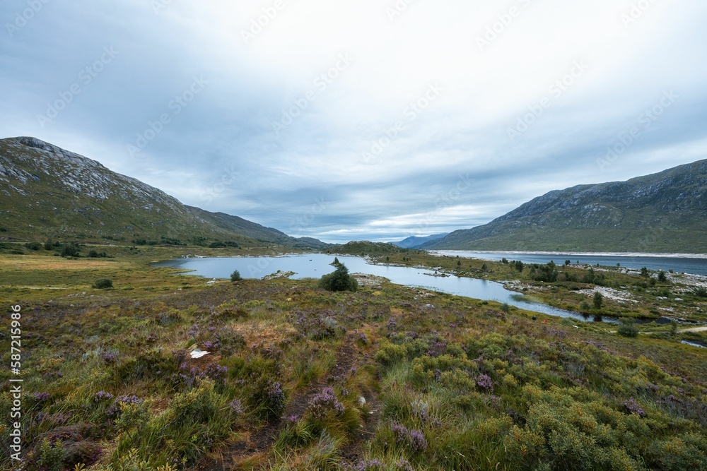 Fototapeta premium Beautiful shot of Loch Cluanie lake and nearby mountains in rural Scotland