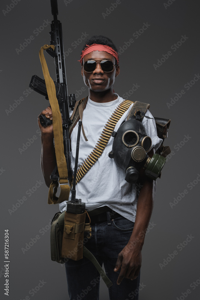 Shot of stylish buccaneer with military equipment and rifle in setting of post apocalyse. Shot of stylish buccaneer with military equipment and rifle in setting of post apocalyse.
