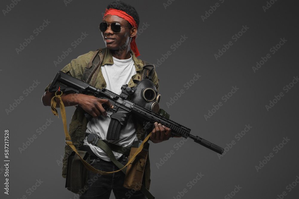 Shot of cheerful pirate of african ethnic with rifle in setting of post apocalypse. Shot of cheerful pirate of african ethnic with rifle in setting of post apocalypse.