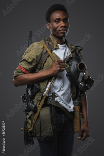 Shot of rebel of african ethnic in post apocalyptic style against grey background.