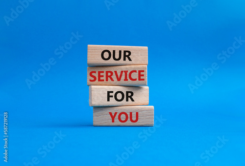 Our service for you symbol. Wooden blocks with words Our service for you. Beautiful blue background. Business and Our service for you concept. Copy space.