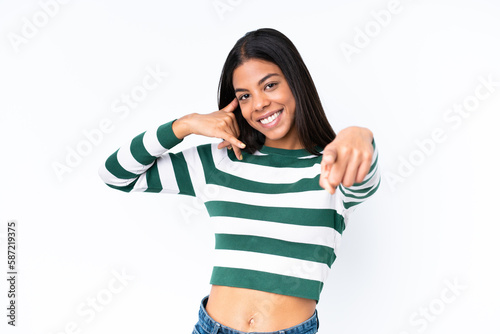 Young African American woman isolated on white background making phone gesture and pointing front