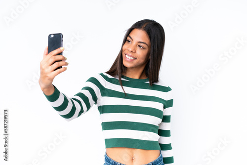 Young African American woman isolated on white background making a selfie