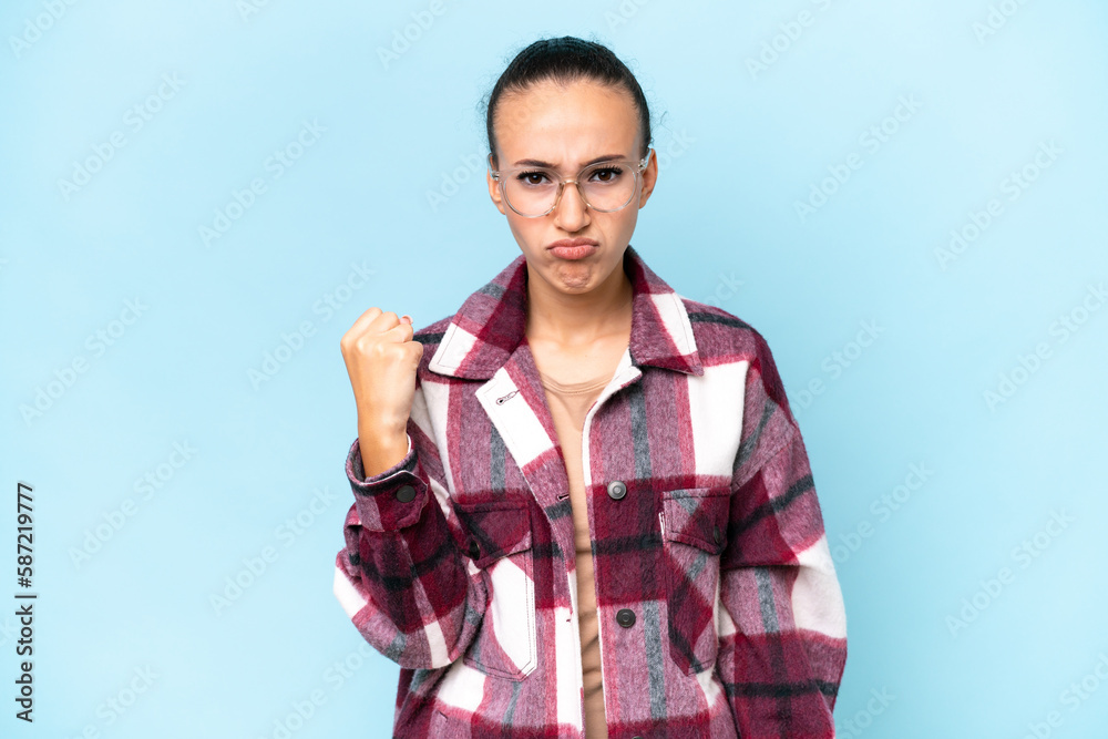 Young Arab woman isolated on blue background with unhappy expression Young Arab woman isolated on blue background with unhappy expression