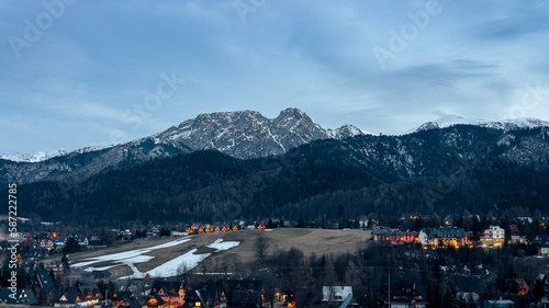 Kościelisko in the evening. Illuminated houses. View of Giewont. Western Tatras. Early spring