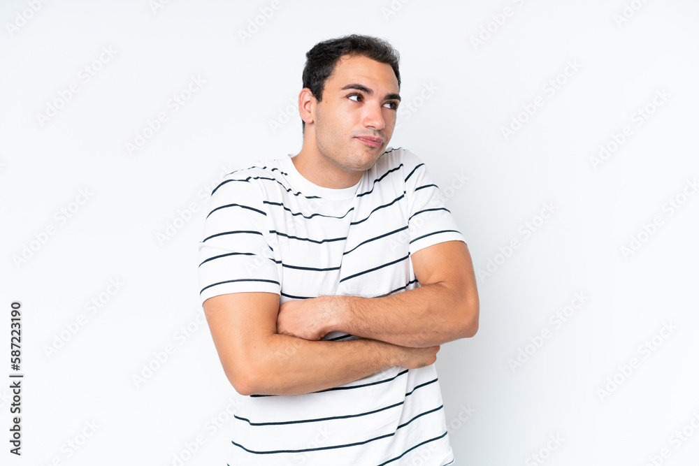 Young caucasian man isolated on white background making doubts gesture while lifting the shoulders Young caucasian man isolated on white background making doubts gesture while lifting the shoulders