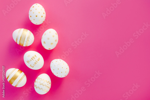 Easter background. Easter golden handmade decorated eggs on pink background. Minimal easter concept. Flat Lay of Golden Easter Eggs