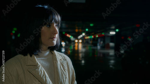 Close up pensive thoughtful serious woman waiting someone wait meeting taxi car automobile looking to side thinking pondering dreaming. Headshot Caucasian female girl at parking lot think portrait