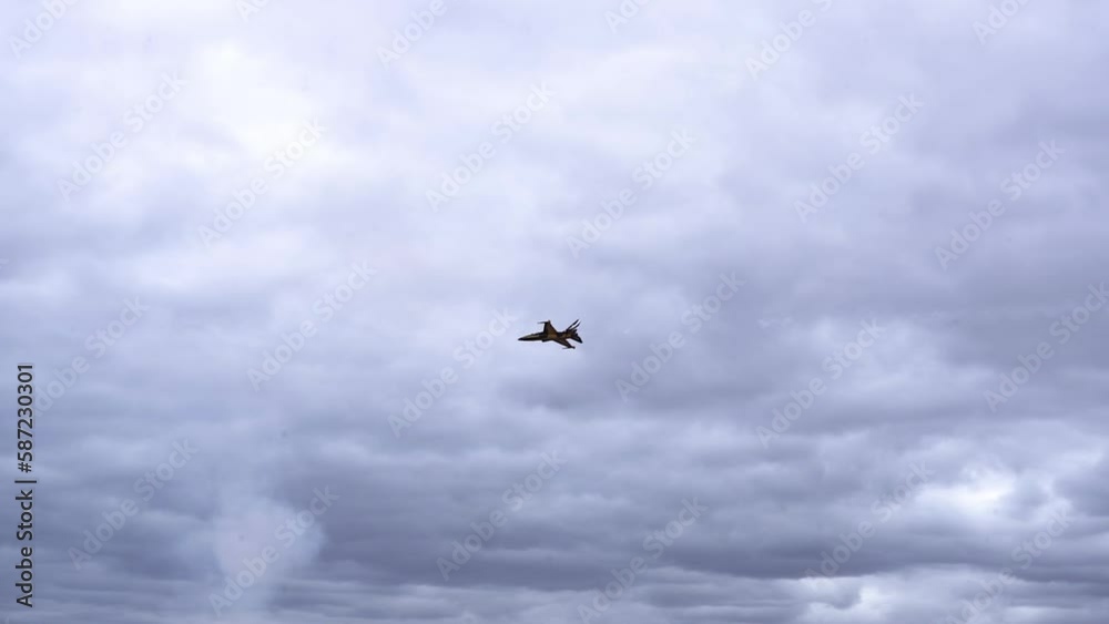 KAI T-50B Jet Planes Soar Against The Clouds In The Sky During Aerial Display. low angle, tracking shot KAI T-50B Jet Planes Soar Against The Clouds In The Sky During Aerial Display. low angle, tracking shot