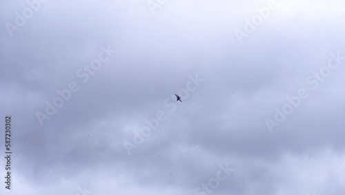 Distant View From Ground Of  FA-18F Super Hornet Fighter Aircraft In Flight Against Dramatic Sky. low angle photo