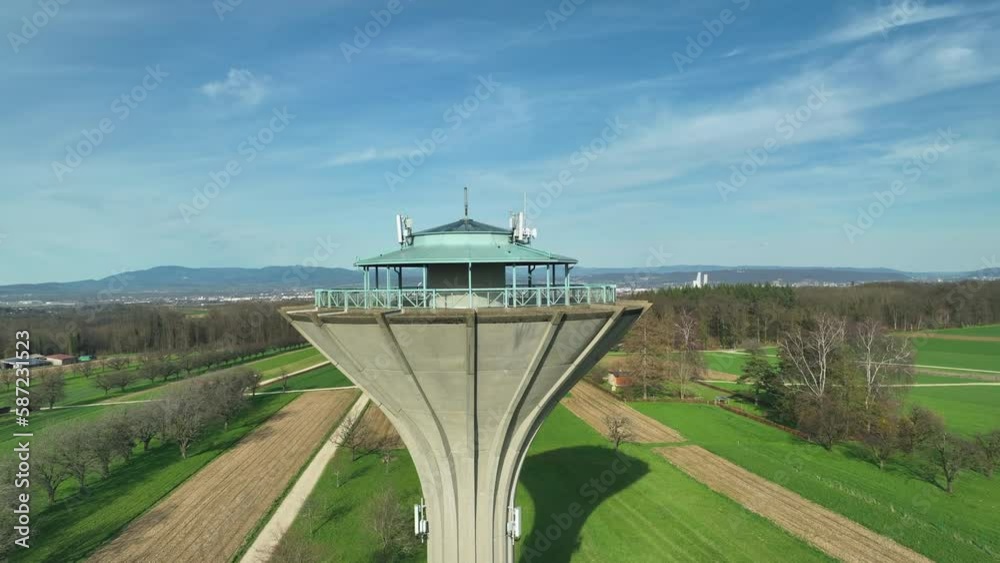 Drone dolley shot over a modern water tower on a sunny day in Switzerland