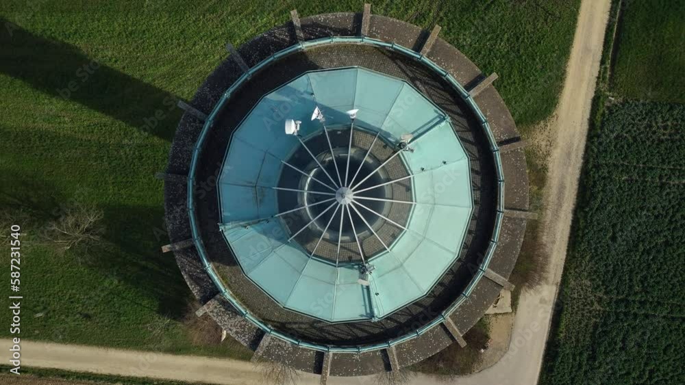 Birdseye drone panning view of a modern water tower on a sunny day