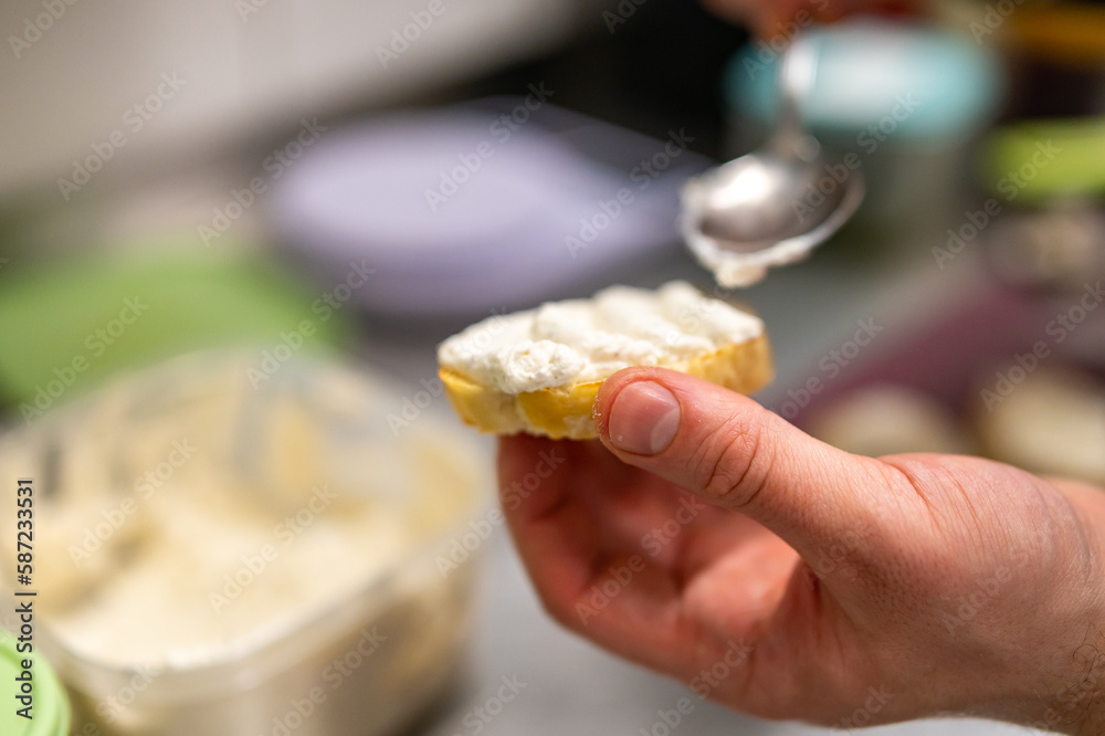 man chef hand cooking tapas with cream cheese on restaurant kitchen man chef hand cooking tapas with cream cheese on restaurant kitchen