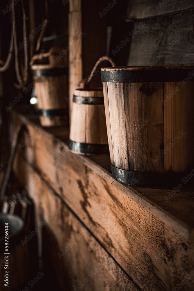 Vertical shot of wooden Buckets on shelf Vertical shot of wooden Buckets on shelf