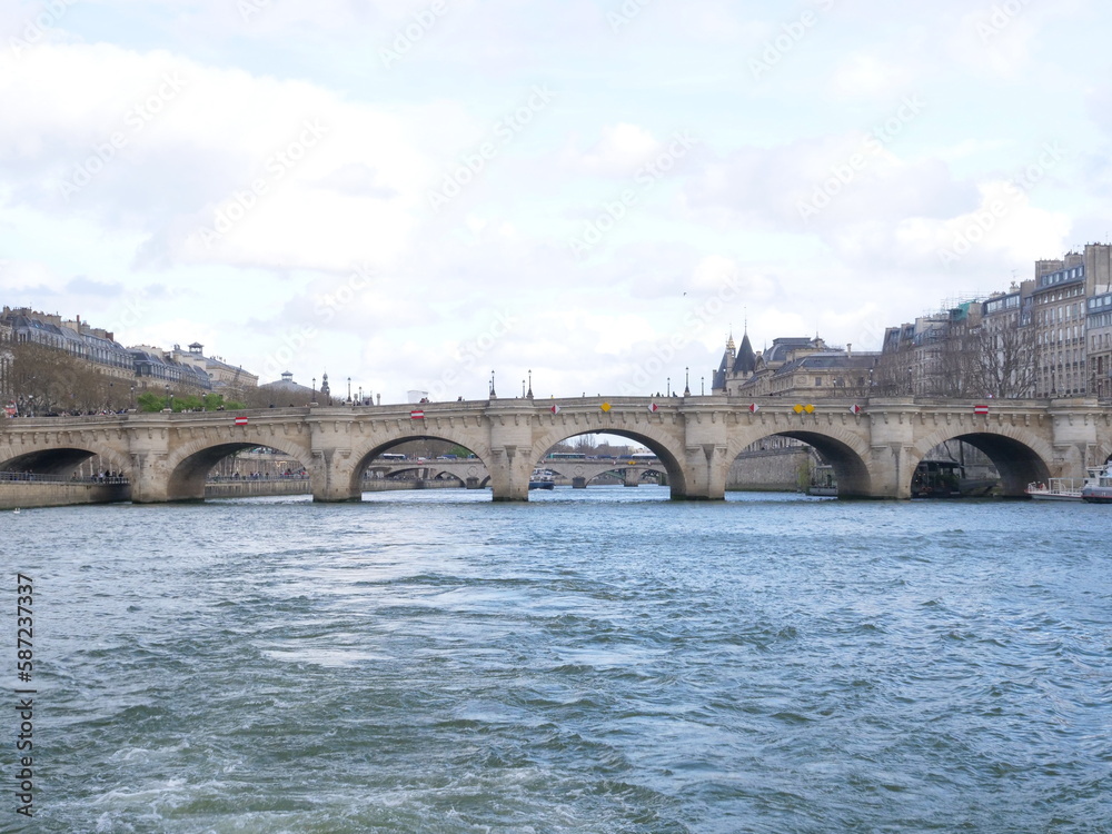 A view from a boat of the Seine river on a cloudy day. 