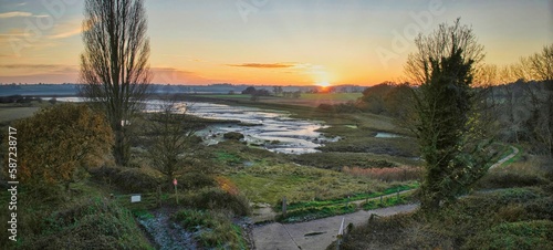 Panoramic aerial view of Levington Lagoon and surrounding greenery at sunset in Suffolk