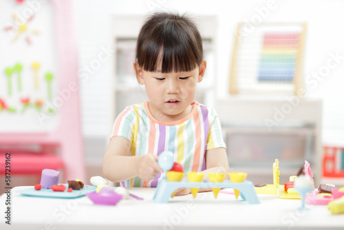 young girl making food using dough tools for homeschooling