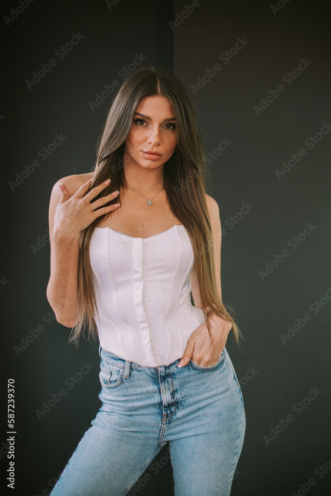 Lovely brunette girl posing on a grey background Lovely brunette girl posing on a grey background