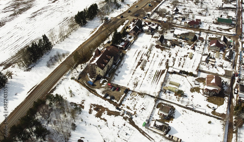 Aerial view of the snowy village. Suburb © Payllik