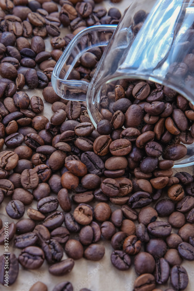 Fototapeta premium Coffee beans in glass jar on crumpled paper background