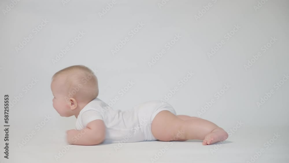 infant on white background learning to crawl infant on white background learning to crawl
