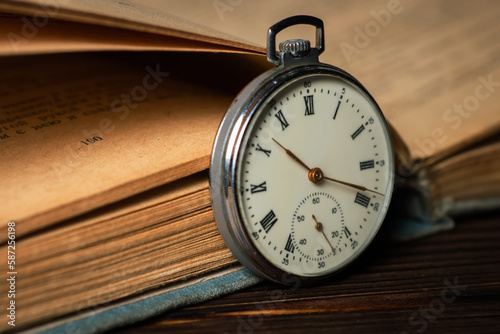 Old vintage watch on books background close up