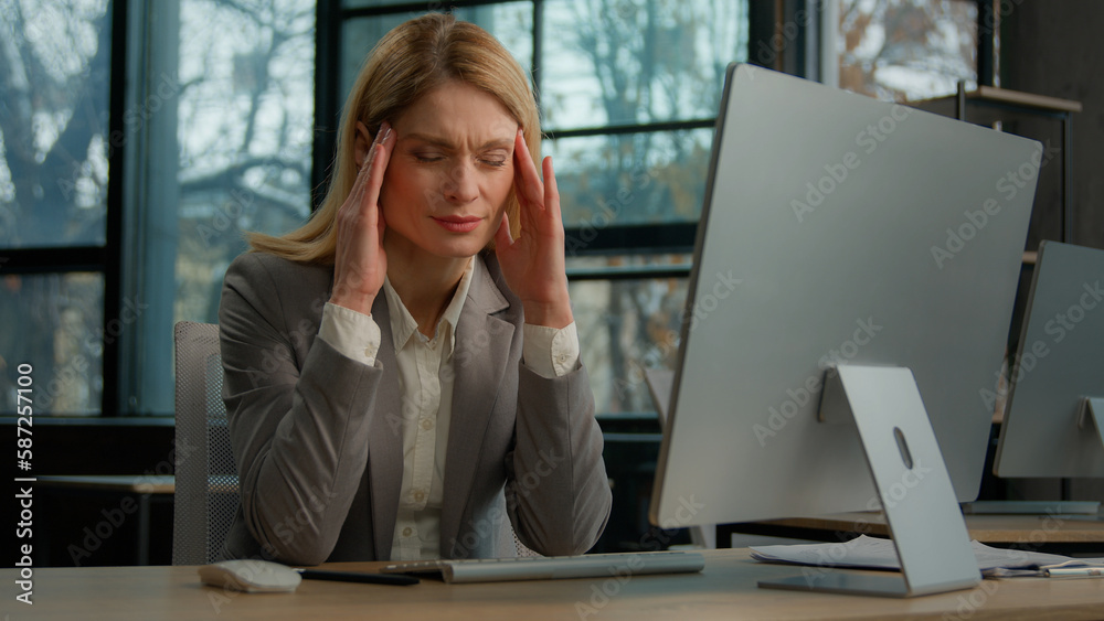 Tired Caucasian adult 40s woman worker businesswoman take pause in online work with computer in office feel painful headache migraine. Female employee overworked by pc feel fatigue suffer from pain Tired Caucasian adult 40s woman worker businesswoman take pause in online work with computer in office feel painful headache migraine. Female employee overworked by pc feel fatigue suffer from pain