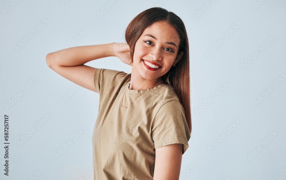 Portrait, smile and a woman in studio on a gray background feeling positive, carefree or cheerful. Face, happy and freedom with an attractive young female posing in clothes for contemporary fashion Portrait, smile and a woman in studio on a gray background feeling positive, carefree or cheerful. Face, happy and freedom with an attractive young female posing in clothes for contemporary fashion