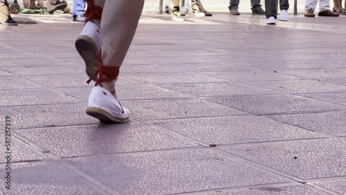 horitzontal video feet of a woman dancing sardanas, with special shoes and typical clothing for dancing sardanas, typical dance in Catalonia