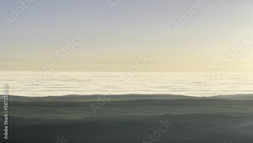 incredible sunset in a sea of ​​clouds from the top of a mountain, 4k vertical video, warm sunset on an adventure day