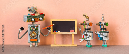Education graduation concept. Toy robot teacher professor and the child robotic students. University classroom with black chalkboard. Machine learning artificial intelligence.