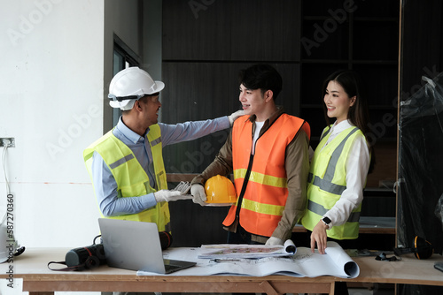 Team of engineers working on a personal computer at a metallurgical workshop.