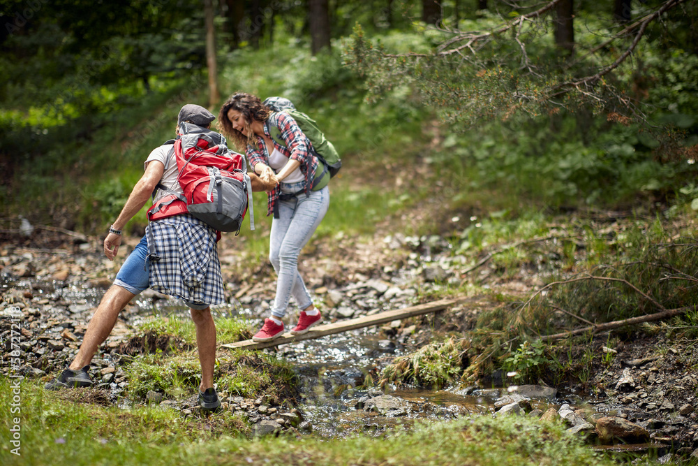 Happy avanturistic traveler couple hiking together
