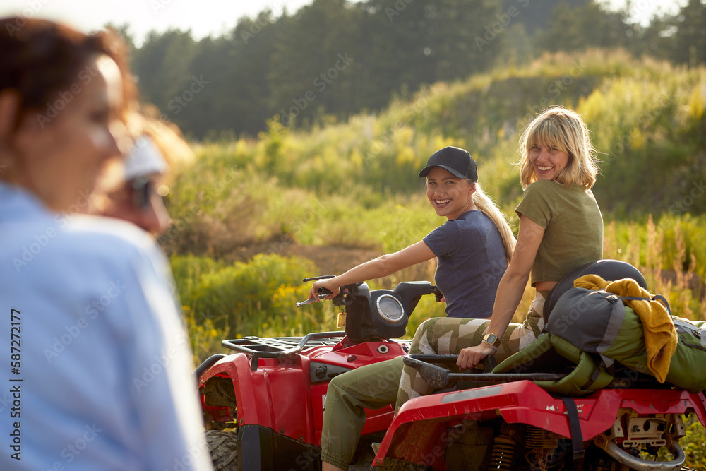 Group of dynamic friends driving quads together Group of dynamic friends driving quads together