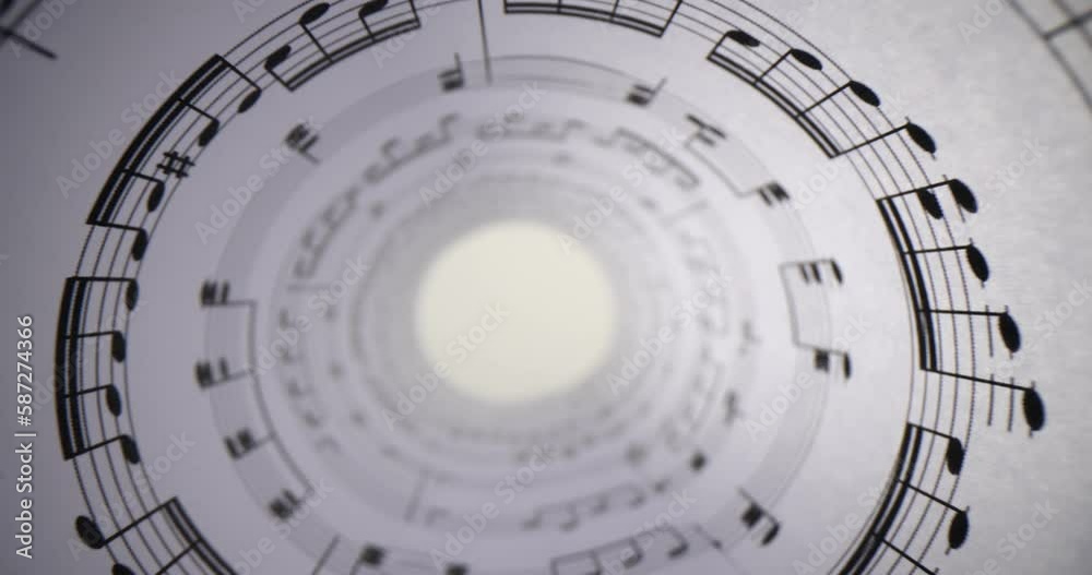White paper with musical notes rolled up closeup and bright light ...