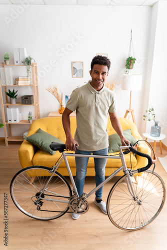 Cheerful black man with bicycle © The Attico Studio