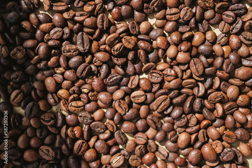 Coffee beans on brown paper background, can be used as a background