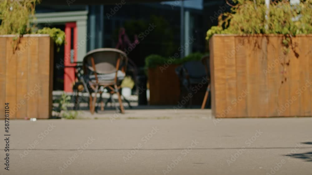 close-up, legs walk down the street past the camera, the girl rides a scooter.