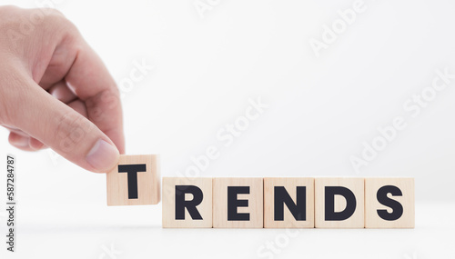Hands laying wooden blocks with the word Trends