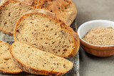 whole grain bread with flax seeds on wooden board, banner, menu, recipe place for text, top view