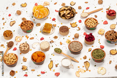 Healthy vegetarian food concept. Assortment of dried fruits, nuts and seeds on white background. Top view. 
