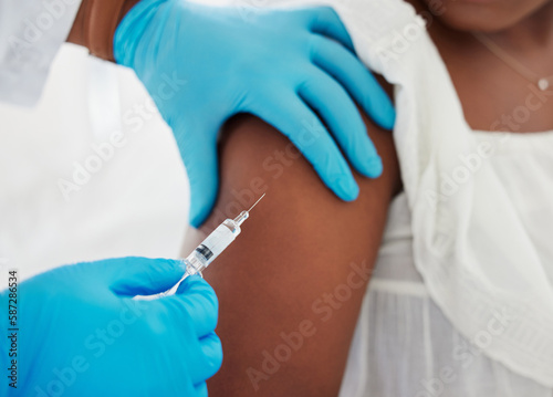 Hand, covid vaccine and a patient closeup with her doctor in a hospital for an injection of medicine antibiotics. Healthcare, medical and consulting with a healthcare professional holding a syringe